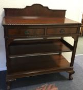 A mahogany two drawer buffet on ball and claw feet