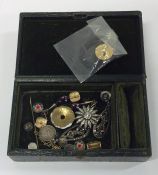 A box containing brooches, ear clips etc. Est. £10