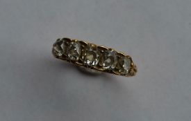 An 18 carat gold diamond five stone carved half ho