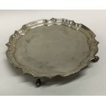 An Edwardian silver pie crust waiter. London. Appr