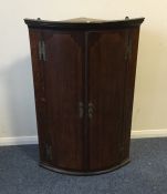 An Antique oak corner cupboard with brass hinges.