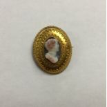 An oval hard stone cameo of a figure in high carat