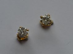 A pair of large diamond single stones mounted as e