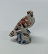 An early pottery figure of a bird. Est. £20 - £30.