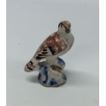 An early pottery figure of a bird. Est. £20 - £30.