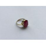 A large oval ruby single stone ring in 18 carat cl