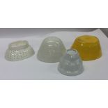 A group of four old jelly moulds. Est. £20 - £30.