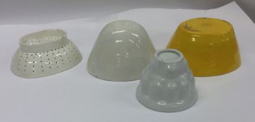 A group of four old jelly moulds. Est. £20 - £30.