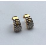 A pair of unusual two colour 18 carat gold earring
