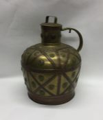 A massive brass and copper urn decorated with stra