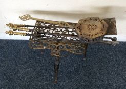 A brass mounted companion set on wrought iron base