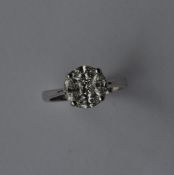 A good diamond five stone circular cluster ring in