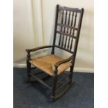 An Antique rocking chair with cane seat. Est. £30