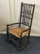 An Antique rocking chair with cane seat. Est. £30