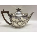 A half fluted Edwardian silver teapot. London. App