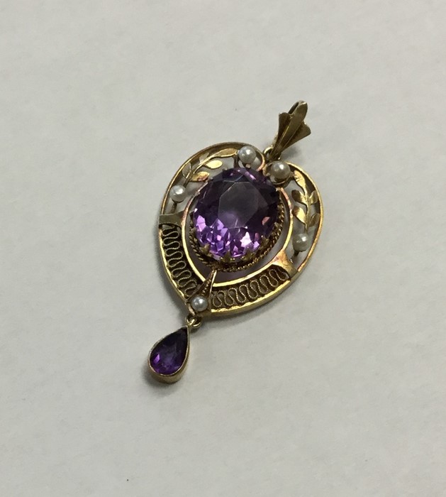 An amethyst and pearl drop pendant with loop top d