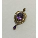 An amethyst and pearl drop pendant with loop top d