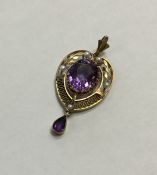 An amethyst and pearl drop pendant with loop top d
