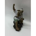 A Japanese model of a fisherman on rocky base. Est