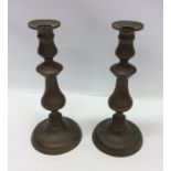 A pair of large circular brass candlesticks. Est.