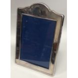 A silver plated dome top picture frame with beaded