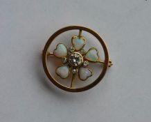 An opal and diamond circular brooch of heart shape