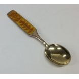 A stylish Continental silver gilt and enamel spoon