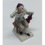An Antique pottery figure of a seated musician on