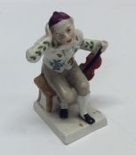 An Antique pottery figure of a seated musician on