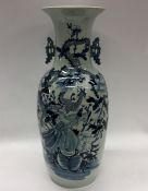 A tall Chinese blue and white vase decorated with