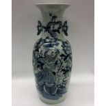 A tall Chinese blue and white vase decorated with