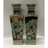 A tall pair of Famille Noir vases of tapering form