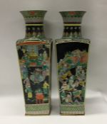 A tall pair of Famille Noir vases of tapering form