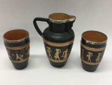 A Doulton Lambeth jug together with two matching b