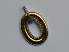 A 9 carat diamond two colour gold pendant with loo