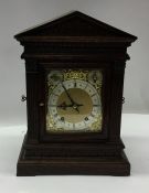 A large oak cased mantle clock with brass dial. Es