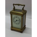 A brass cased carriage clock with white enamelled