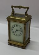 A brass cased carriage clock with white enamelled