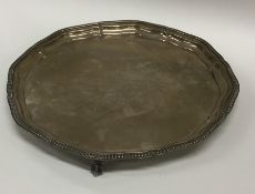 A circular silver salver with gadroon rim. Present