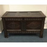 A Georgian oak hinged top coffer with carved front