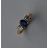 An attractive diamond and sapphire three stone rin