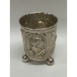 A 19th Century silver beaker on ball feet decorate