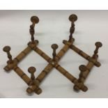 An unusual satinwood coat hanger of bamboo form. E