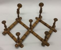 An unusual satinwood coat hanger of bamboo form. E