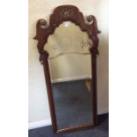 A tall Continental ornate arched top wooden framed mirror. Est. £30 - £40.