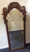 A tall Continental ornate arched top wooden framed mirror. Est. £30 - £40.