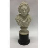 An alabaster bust of Beethoven on wooden pedestal