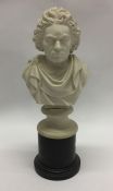 An alabaster bust of Beethoven on wooden pedestal