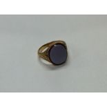 A small gent's gold signet ring with engraved deco