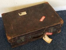 A crocodile skin suitcase with brass hinges. Est.